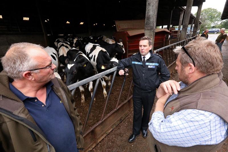 Police constable talking to dairy farmer
