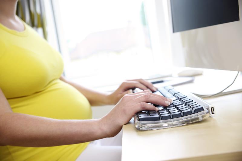 Pregnant woman at computer