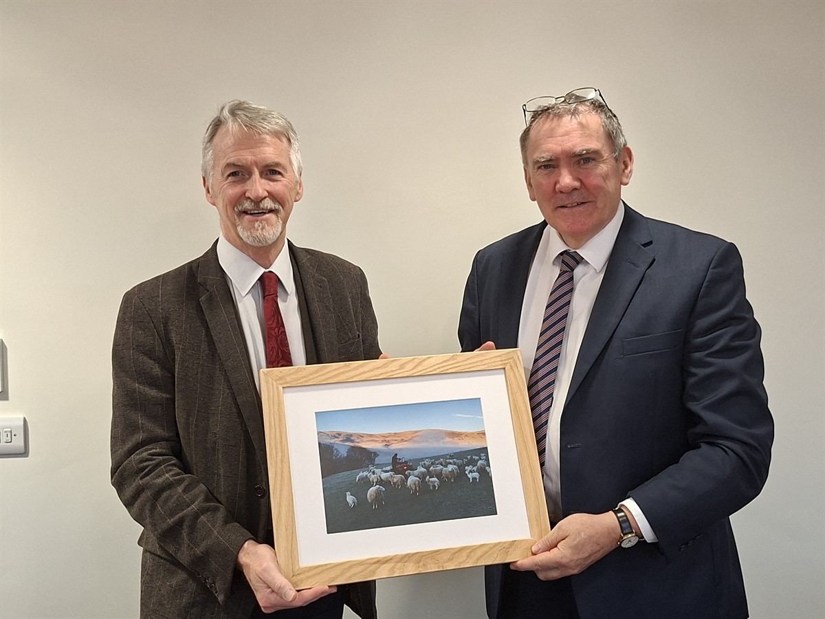 Aled Jones presenting winning picture to Deputy First Minister