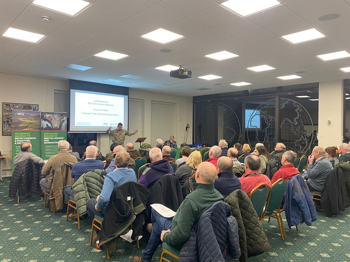 A photo of Major Andy Butcher speaking to the conference