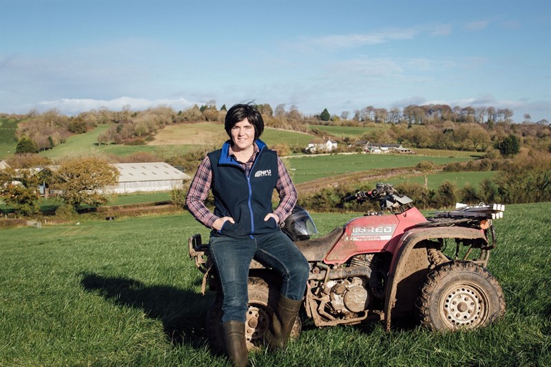NFU Cymru Deputy President Abi Reader stood next to an ATV on farm
