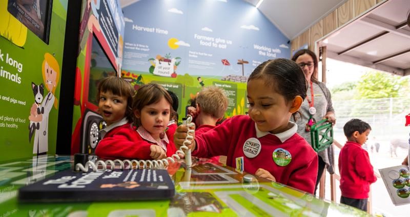 A child use an interactive display to learn about British farming