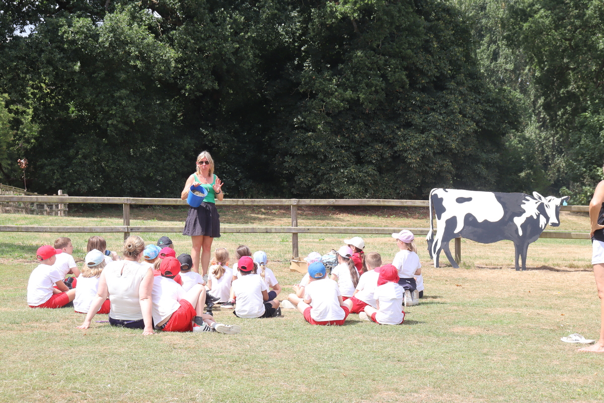Sarah Procter teaching children farming facts in a field in Belvoir