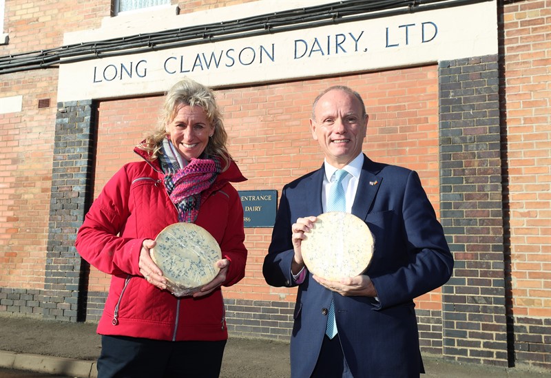 Minette Batters and Mike Freer holding wheels of Stilton cheese