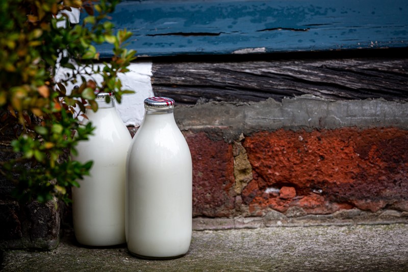 An image showing milk bottles on a step 