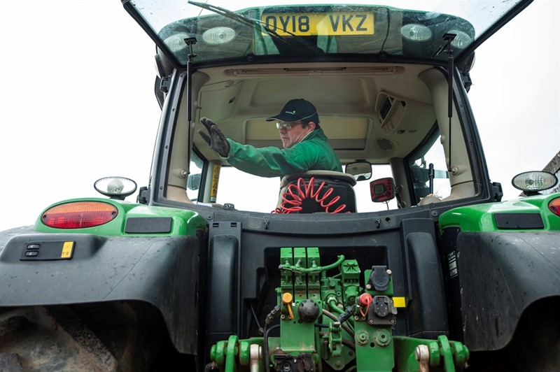 A farmer pictured in a tractor cab