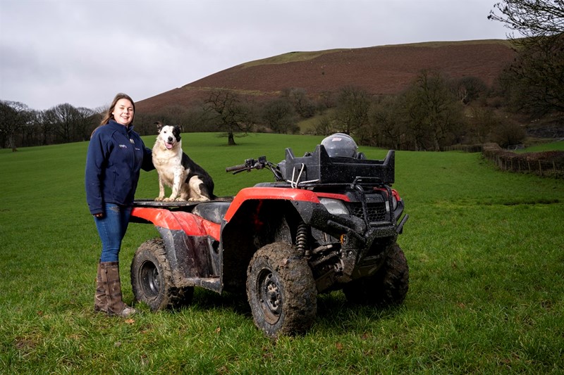 Sian Davies stood next to an ATV with her dog