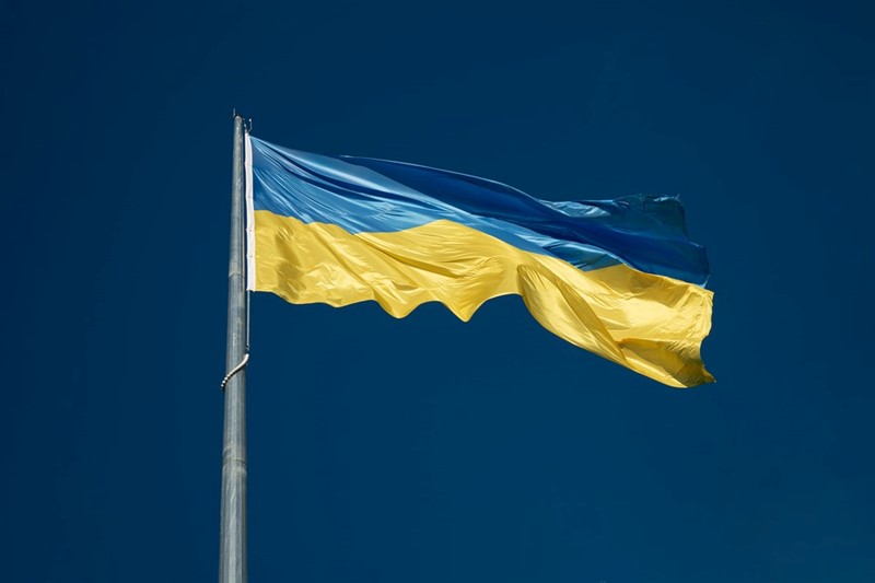 The flag of Ukraine against a blue sky