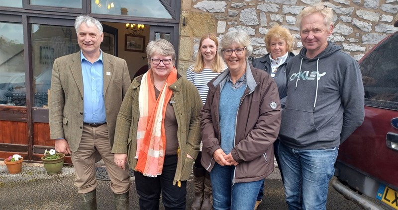 Defra SoS Therese Coffey with farmers during a visit to the Peak District