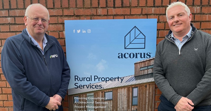 NFU Commercial & Investment Director Ken Sutherland and Acorus Managing Director James Whilding standing next to anm Acorus sign smiling
