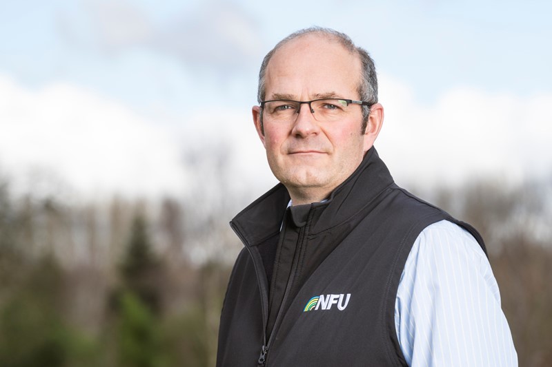 Headshot of NFU President Tom Bradshaw standing in field