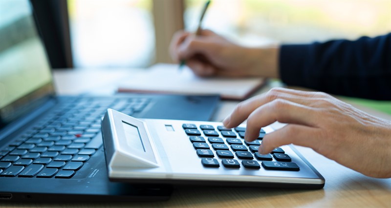 Calculator and laptop on desk