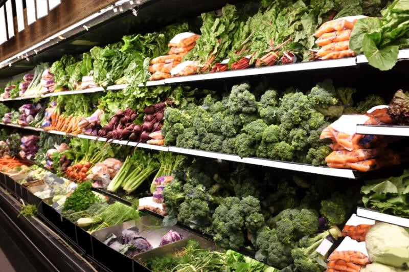 Green vegetables on shelves in a supermarket