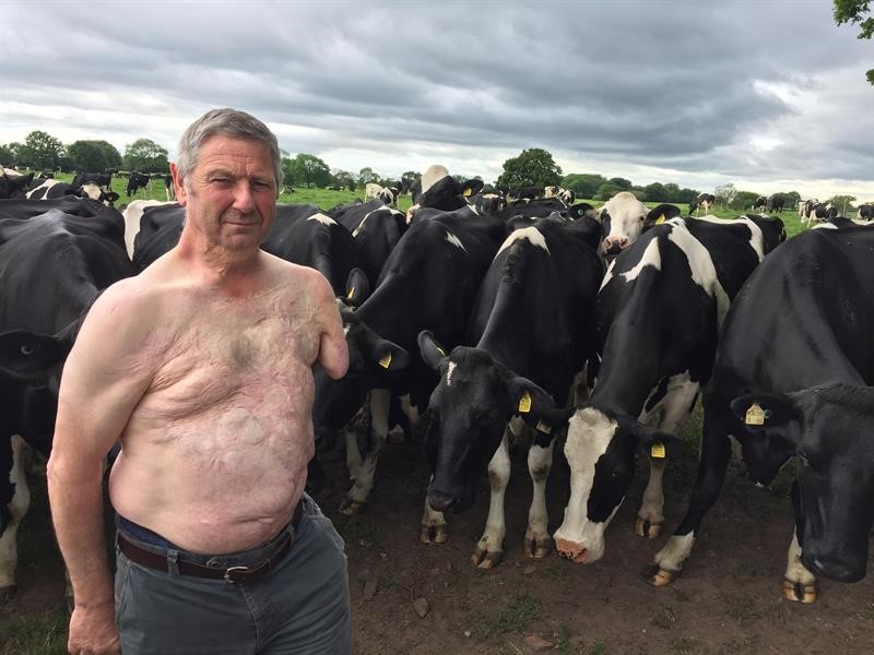 Kit Hopley standing in a field of cows