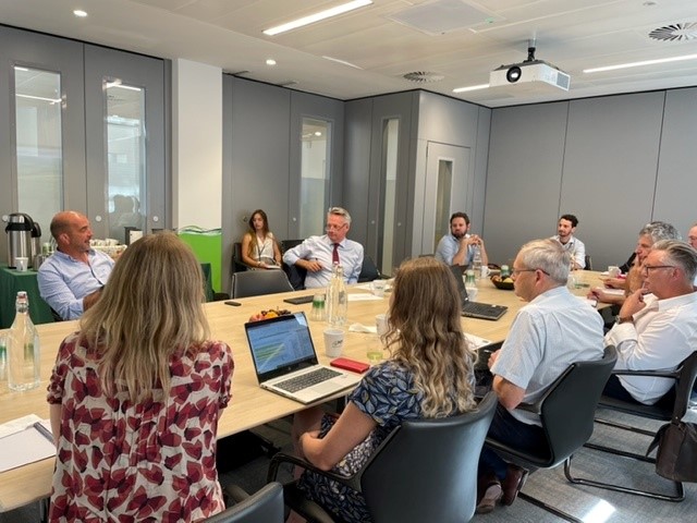 A picture of participants of the soils roundtable sat around a table