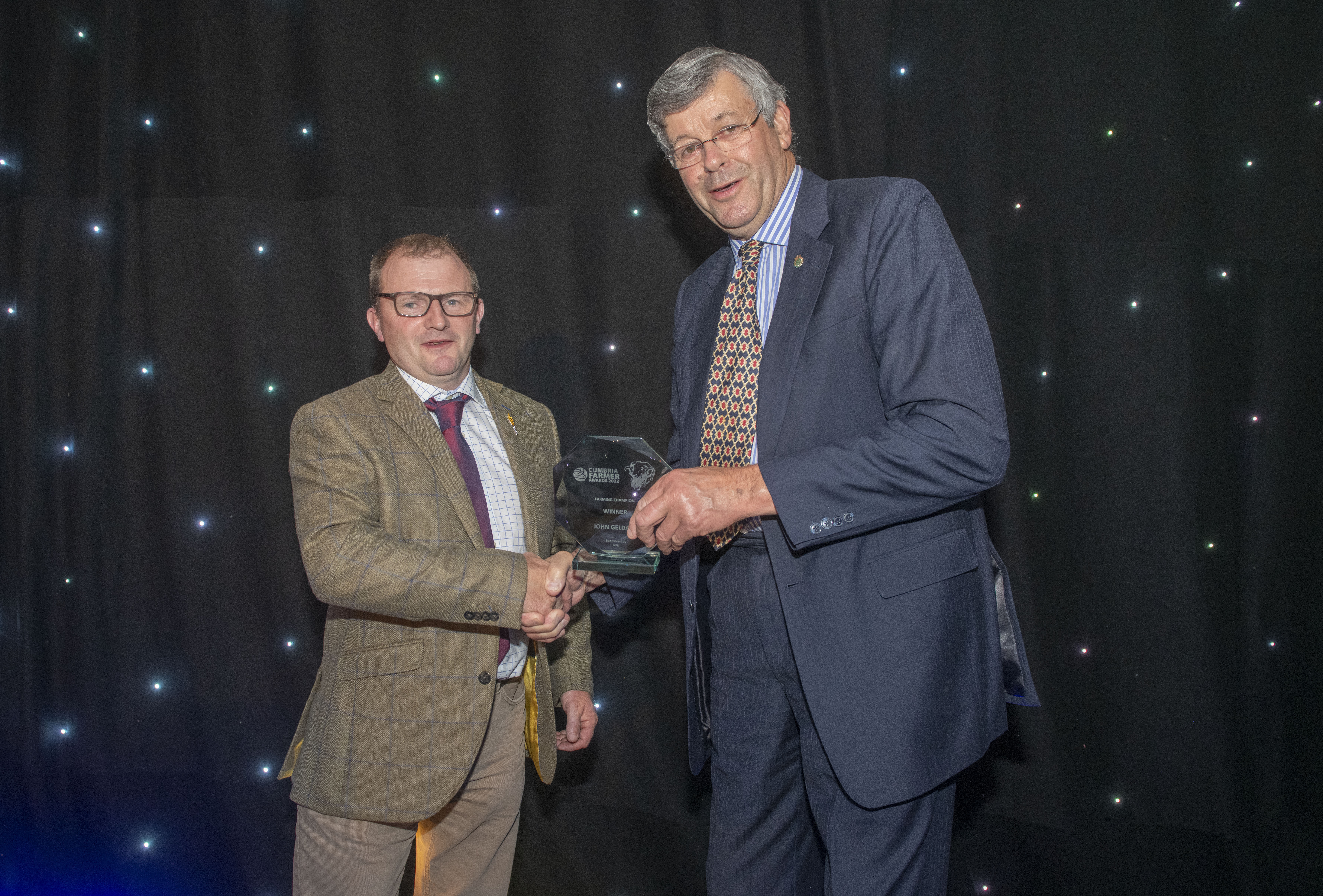 NFU Cumbria County Chairman Ian Bowness presents John Geldard with his Farming Champion Award with his