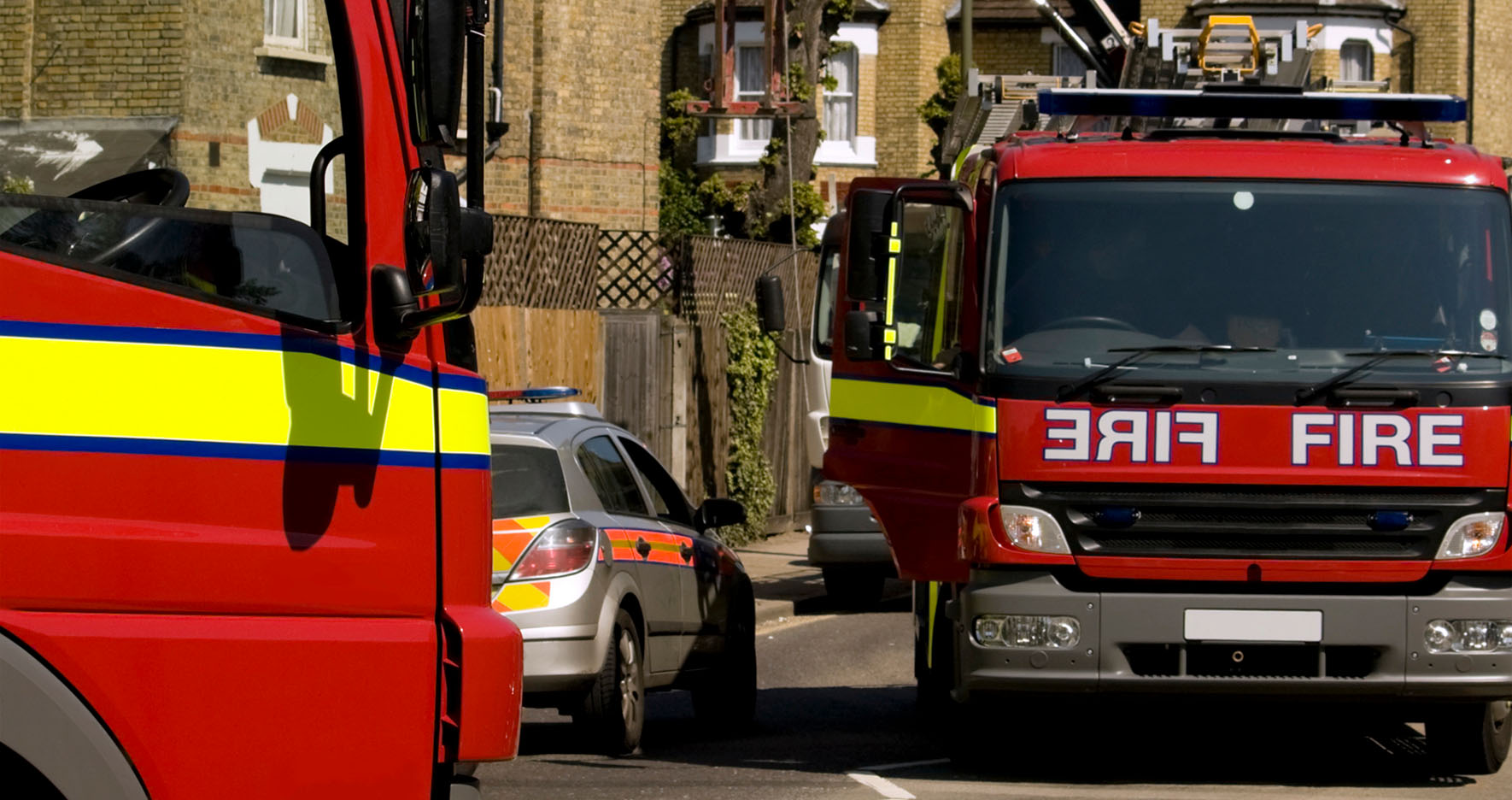 Two fire engines parked outside a building