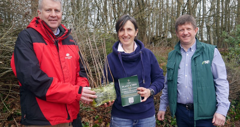Camilla White is handed a pack of trees by David Rickwood of the Woodland Trust. Exeter group secretary Mark Potter looks on.