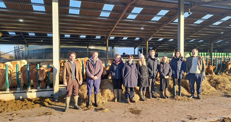 An image of the new agri-food attachés stood in front of a cow shed
