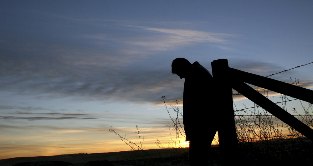 Silhouette of a farmer in a field