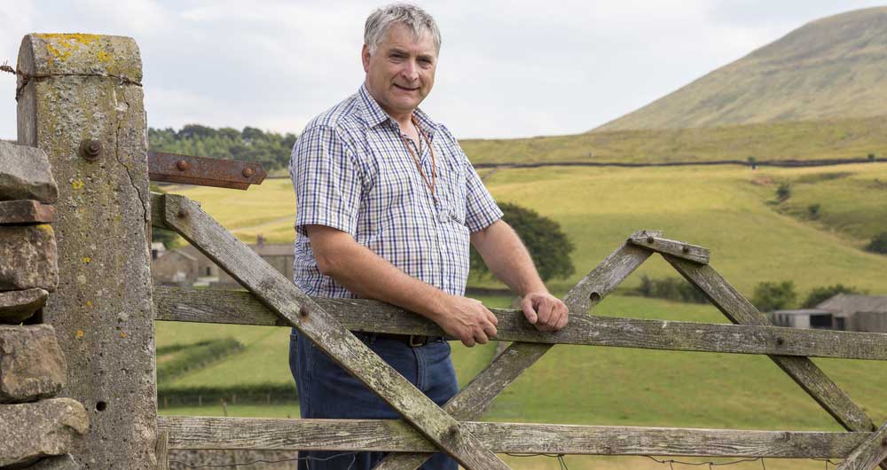 Thomas Binns standing by a gate