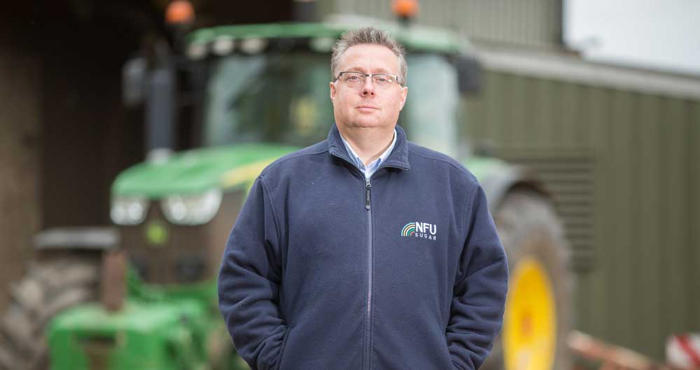 NFU Sugar Board Chairman Michael Sly standing in front of his tractor