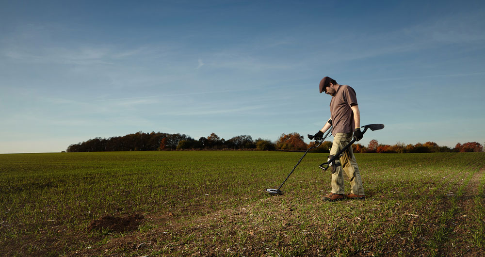 Metal detectorist on farmland