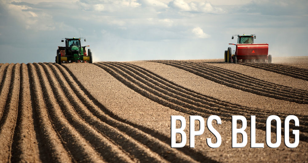 A BPS blog header image with tractors on ploughed field