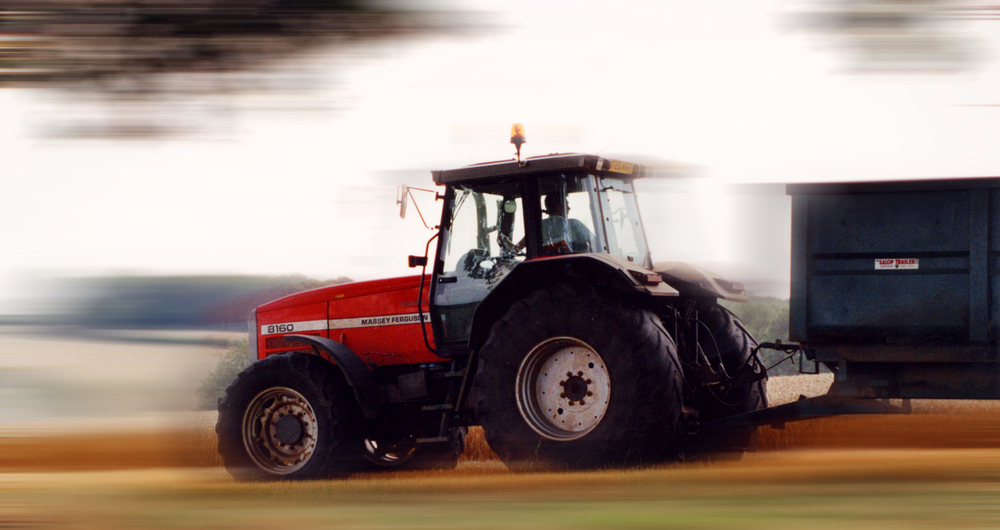 A tractor moving at speed pulling a trailer