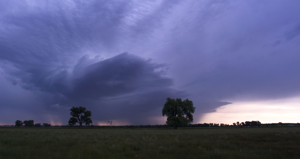 Stormy evening at sunset over fields