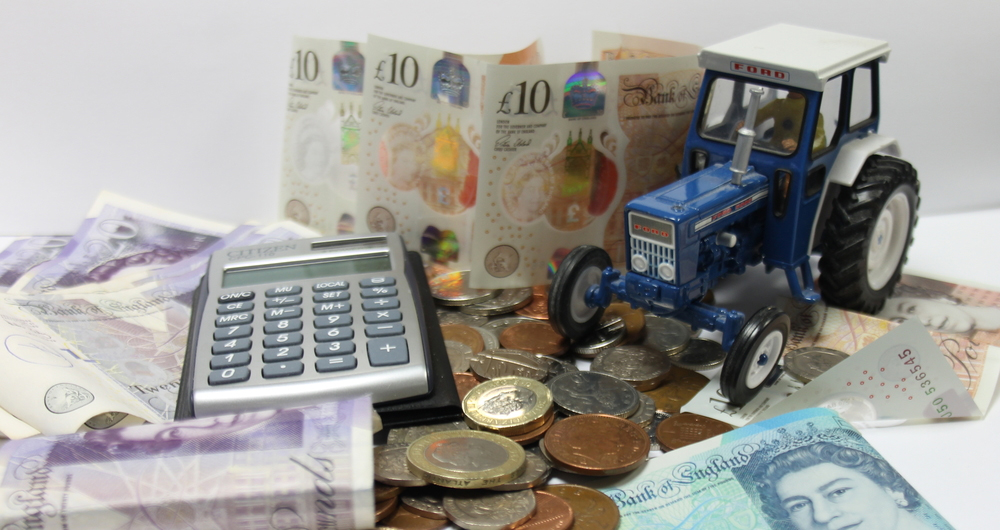 A tractor surrounded by money and a calculator