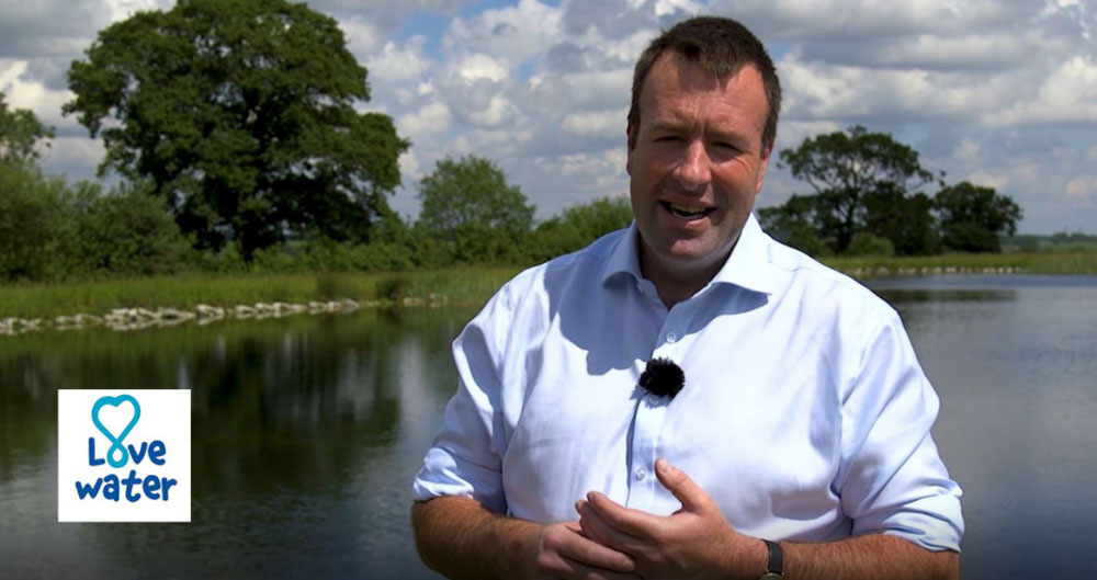 A photograph of NFU Deputy President Stuart Roberts against the backdrop of a reservoir