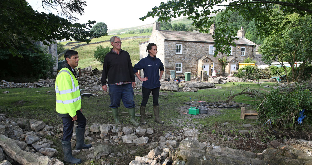 Dales floods - Rishi Sunak MP surveys the devastation with farmer Raymond Calvert and group secretary, Lindsey-Anne Murfin