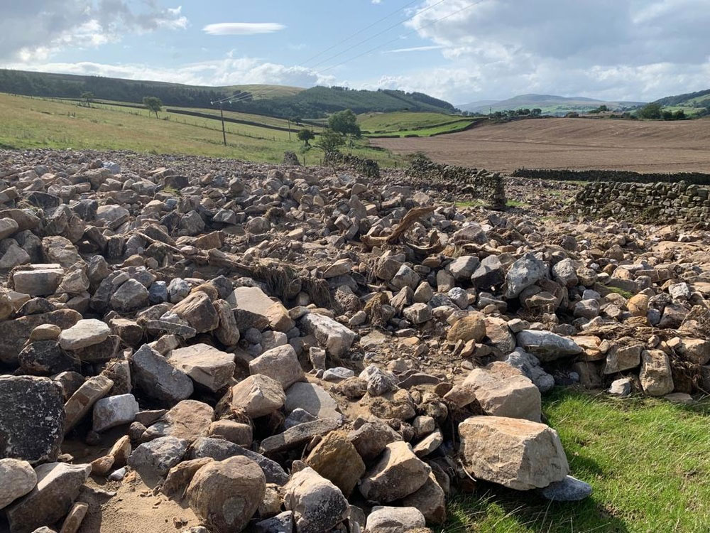A photograph of stone walls damaged by floods in Yorkshire Dales in July 2019