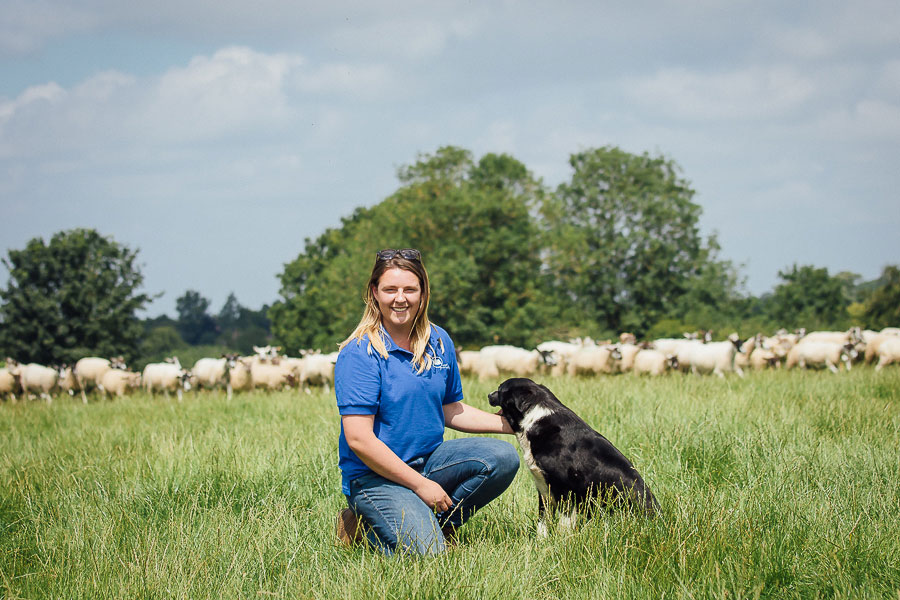 Charlie Beaty on farm with her sheap dog and stock