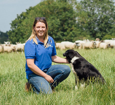 Charlie Beaty on farm with her sheap dog and stock