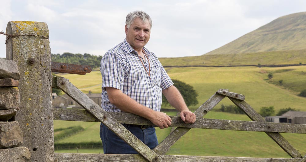 Thomas Binns standing by a gate