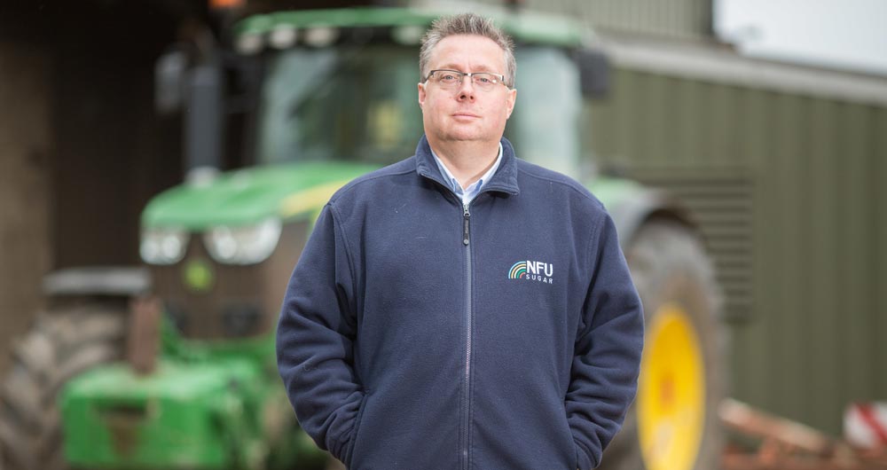 NFU Sugar Board Chairman Michael Sly standing in front of his tractor