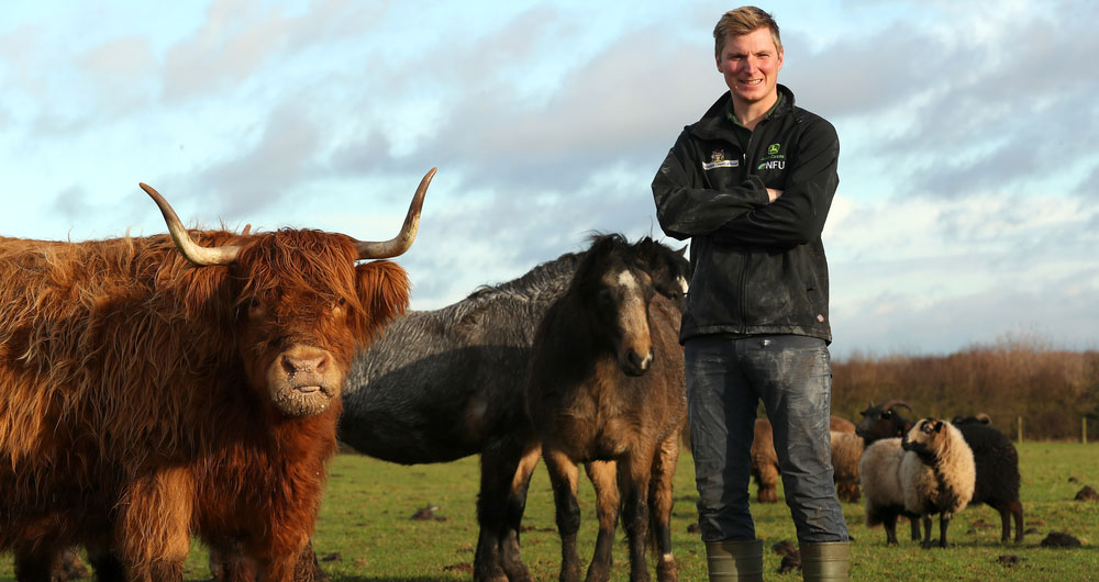 Richard Bower stands next to livestock