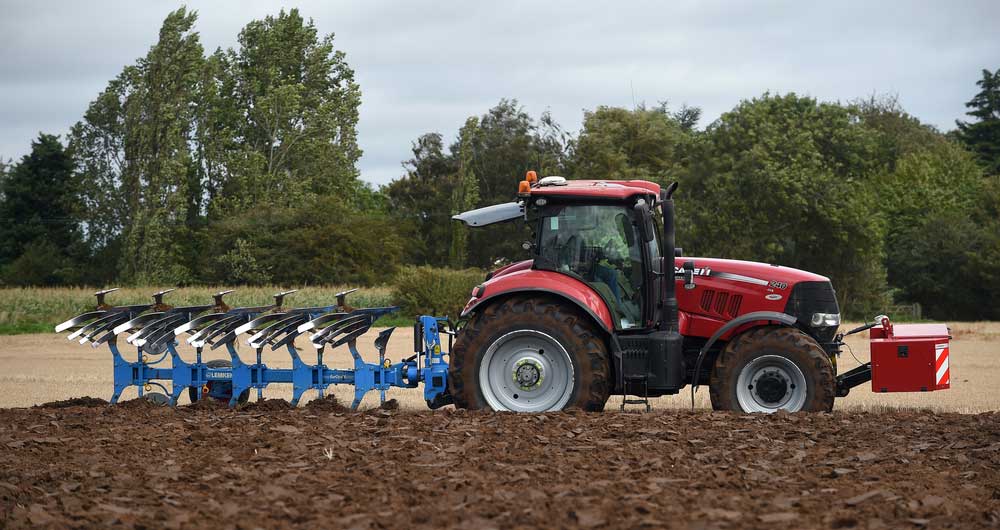 A tractor working in the fields on the Norfolk/Cambridgshire border