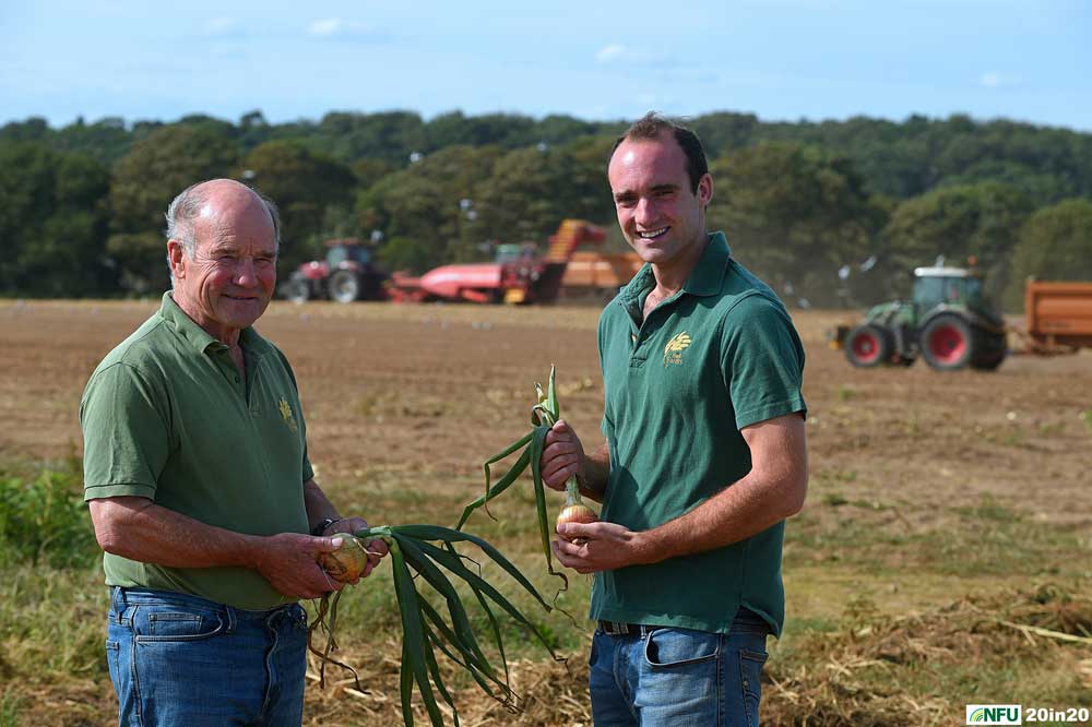 <h4>Bringing in the onions at Covehithe</h4><p>Father and son Roger and Chris Middleditch during the harvest of onions on their fields close to the cliffs at Covehithe. Photo: Nikon D4s + 80-200mm F2.8 135mm 1/500 @ F11 ISO 250</p><p>Warren’s comments: <em>Farming is about people and this shot features father and son Roger and Chris Middleditch. The aim was to show all the activity going on in the background without distracting from them.</em></p>