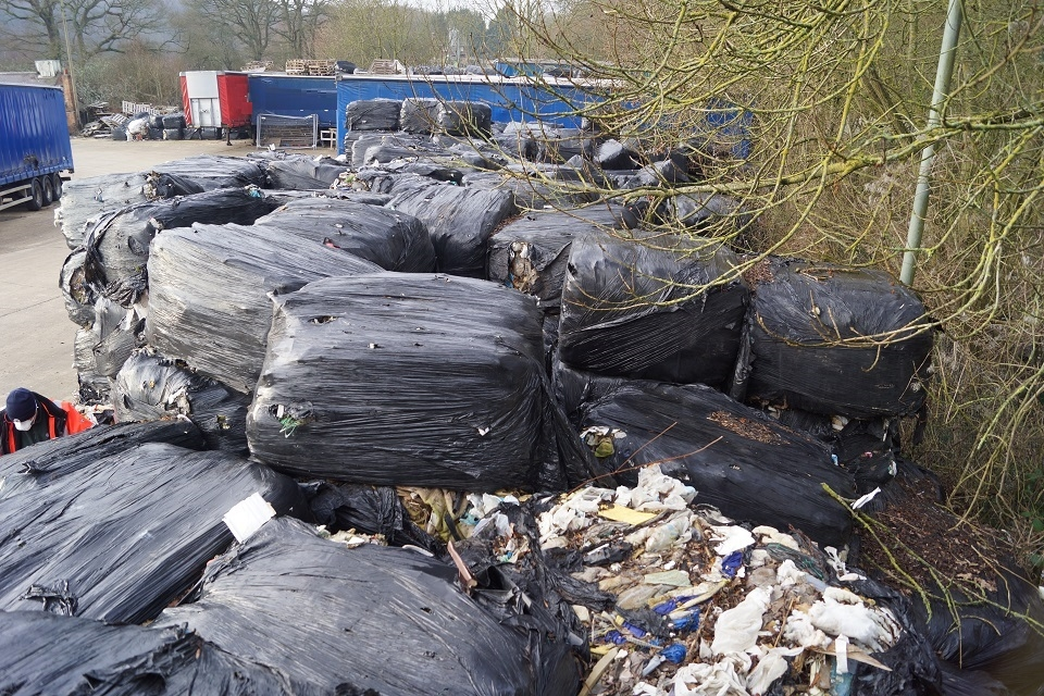 A pile of baled waste, bales splitting open to reveal contents