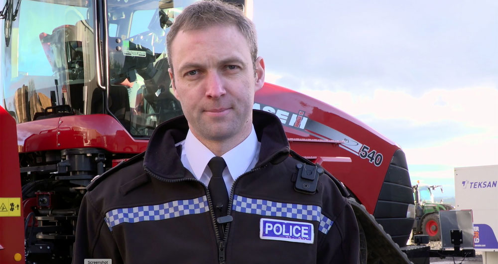 Andy Huddlestone from Northumbria Police standing in front of a tractor