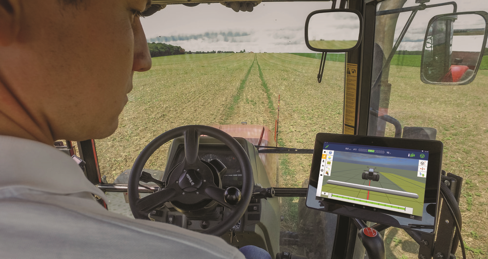 Man drives tractor with GPS in field